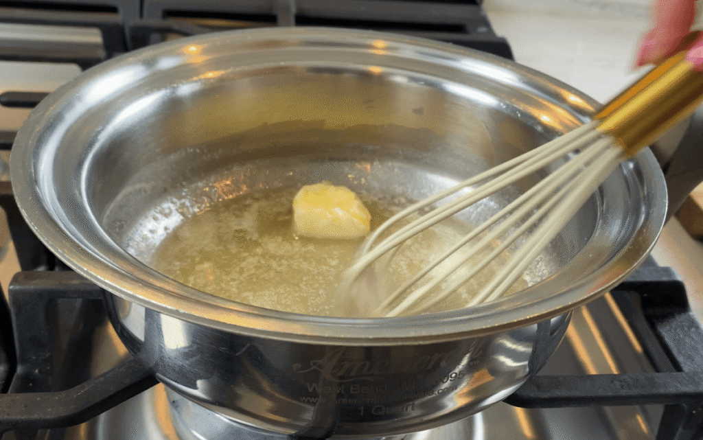 Butter melting on low heat in a saucepan to start a cream sauce