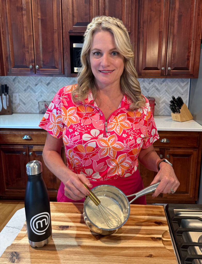 Erin Cormier whisking a sauce in her kitchen in the outfit she wore on MasterChef Season 16