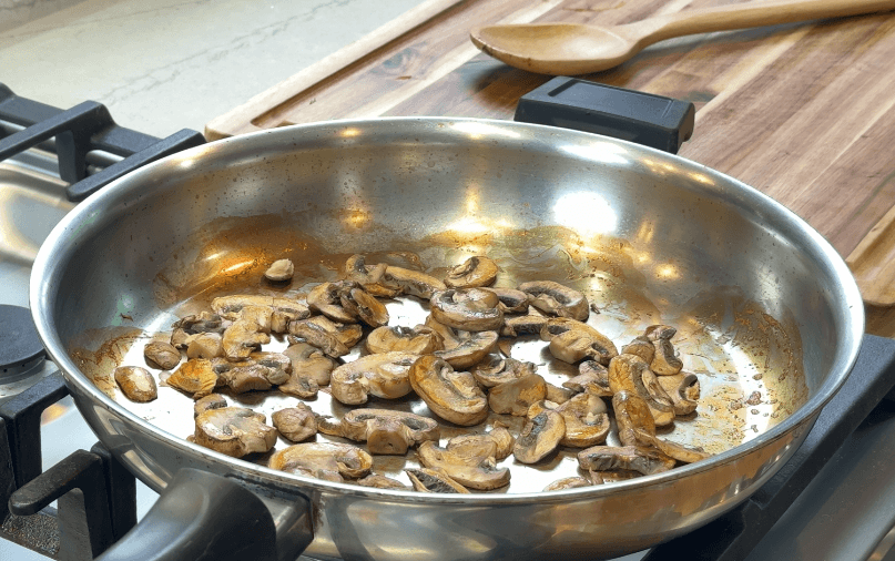 Mushrooms collapsed and ready to brown in a dry pan after water has evaporated