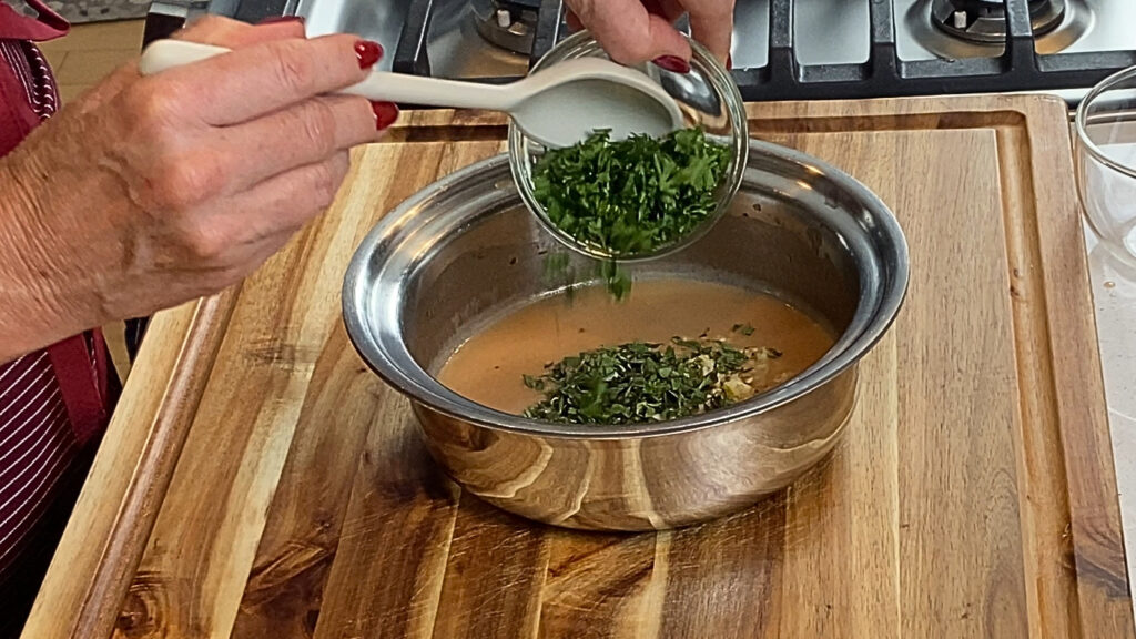 Fresh chopped herbs folded into the finished chimichurri butter sauce