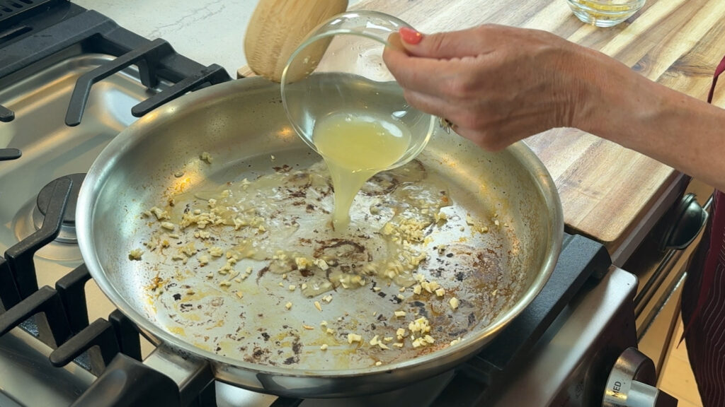 Lemon juice and zest deglazing a pan to build a lemon butter sauce base