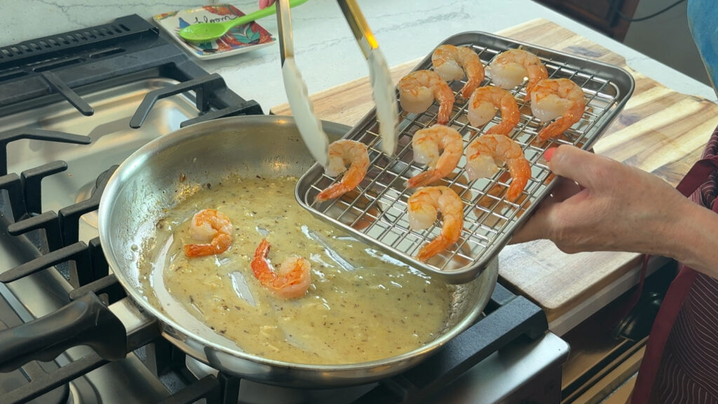 Seared shrimp returned to lemon butter sauce to finish cooking