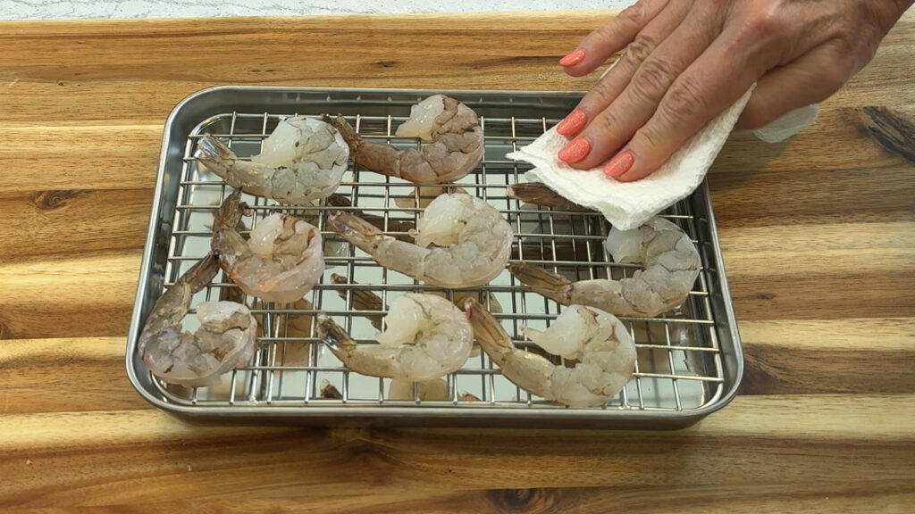 Raw shrimp patted dry and resting uncovered before searing