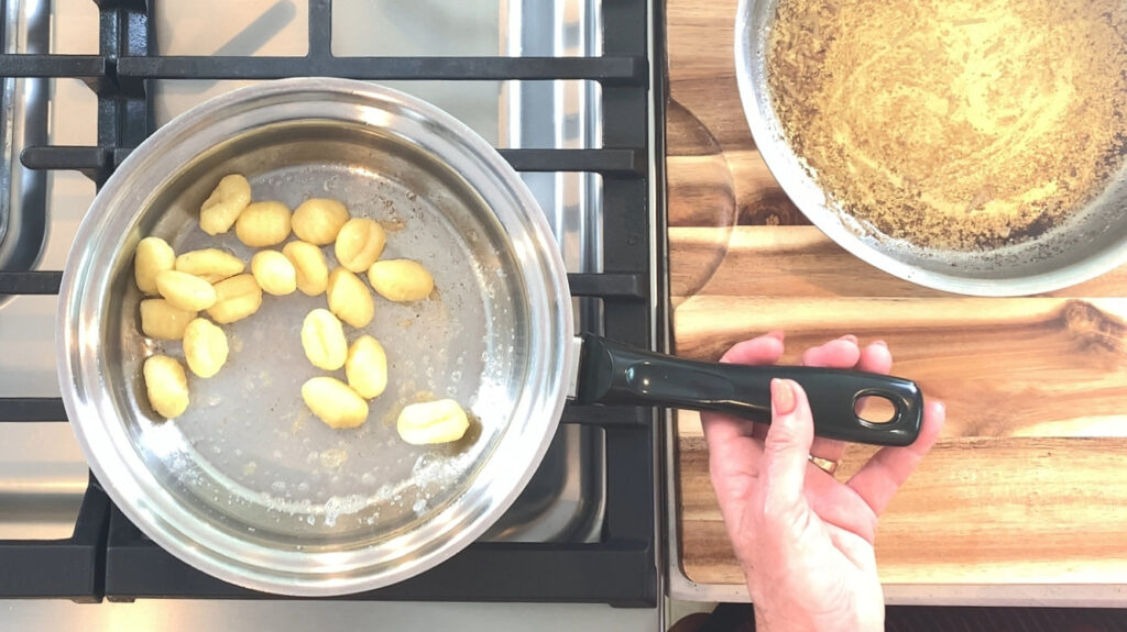 Browning cooked gnocchi.