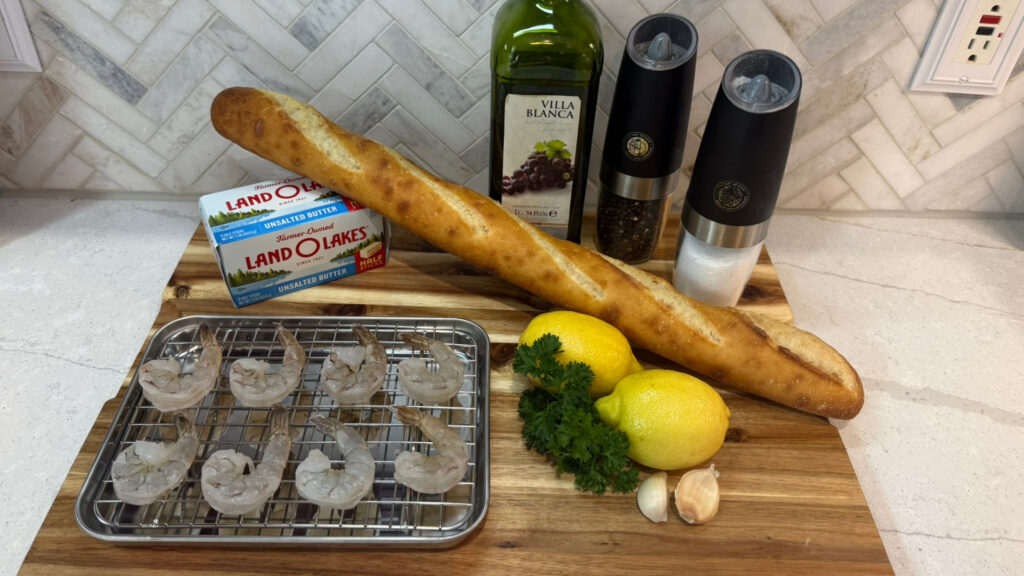 Ingredients for lemon butter sauce: butter, garlic, lemon, and parsley on a cutting board