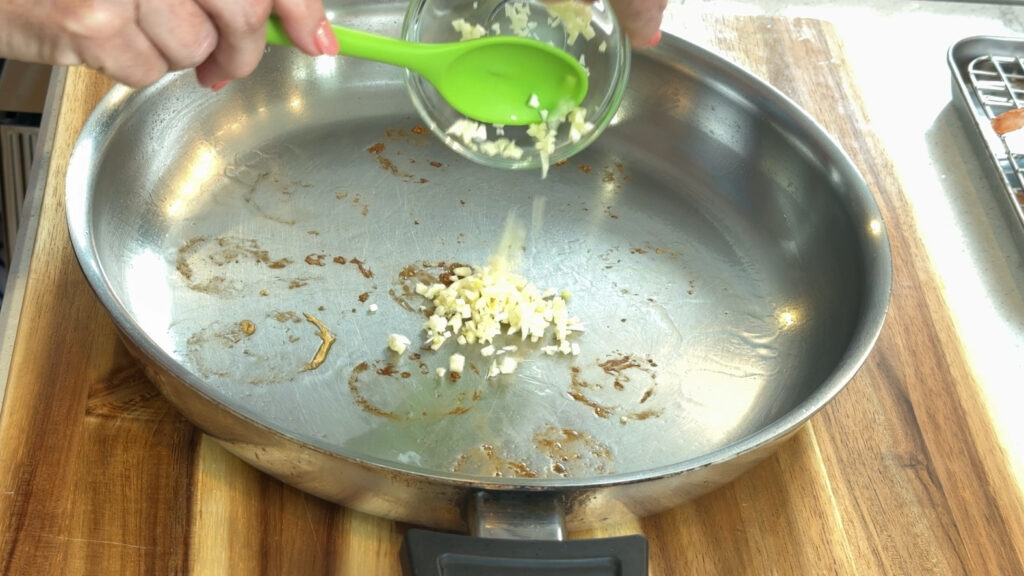 Minced garlic blooming in a pan off the heat to prevent burning