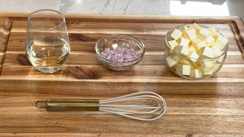 White wine, minced shallots, and cubed cold butter measured out for beurre blanc sauce