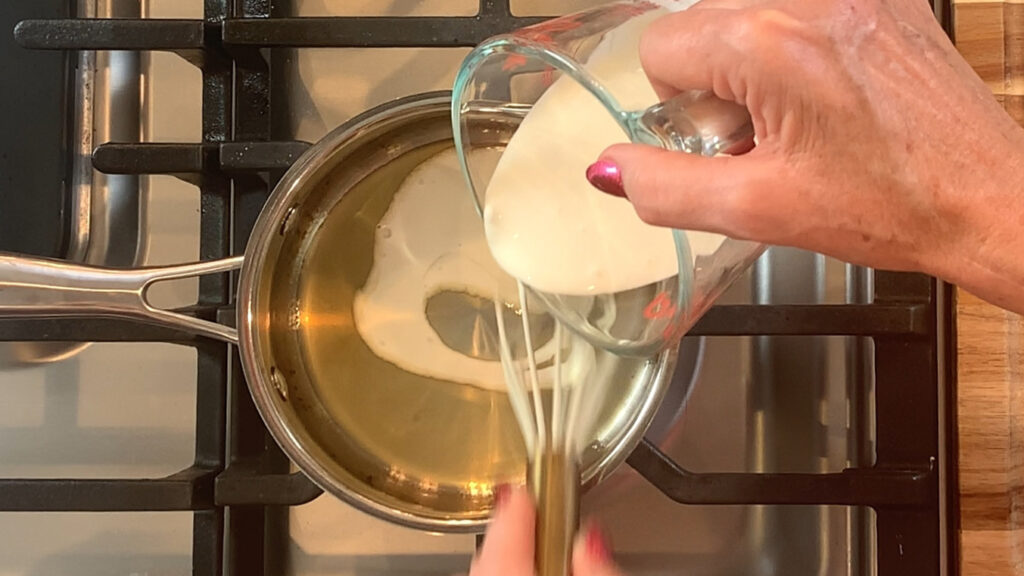 Cream being whisked into reduced lemon.
