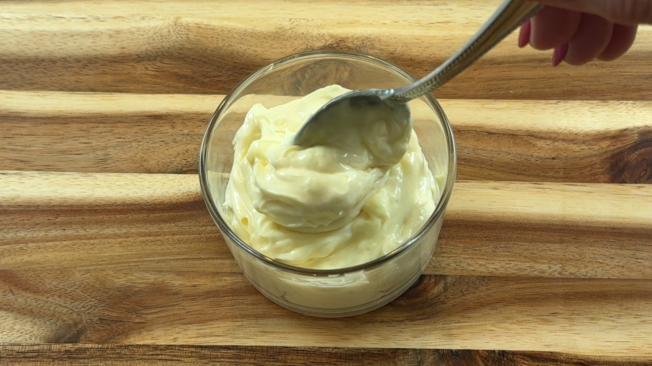 Bowl of smooth, glossy homemade mayonnaise.