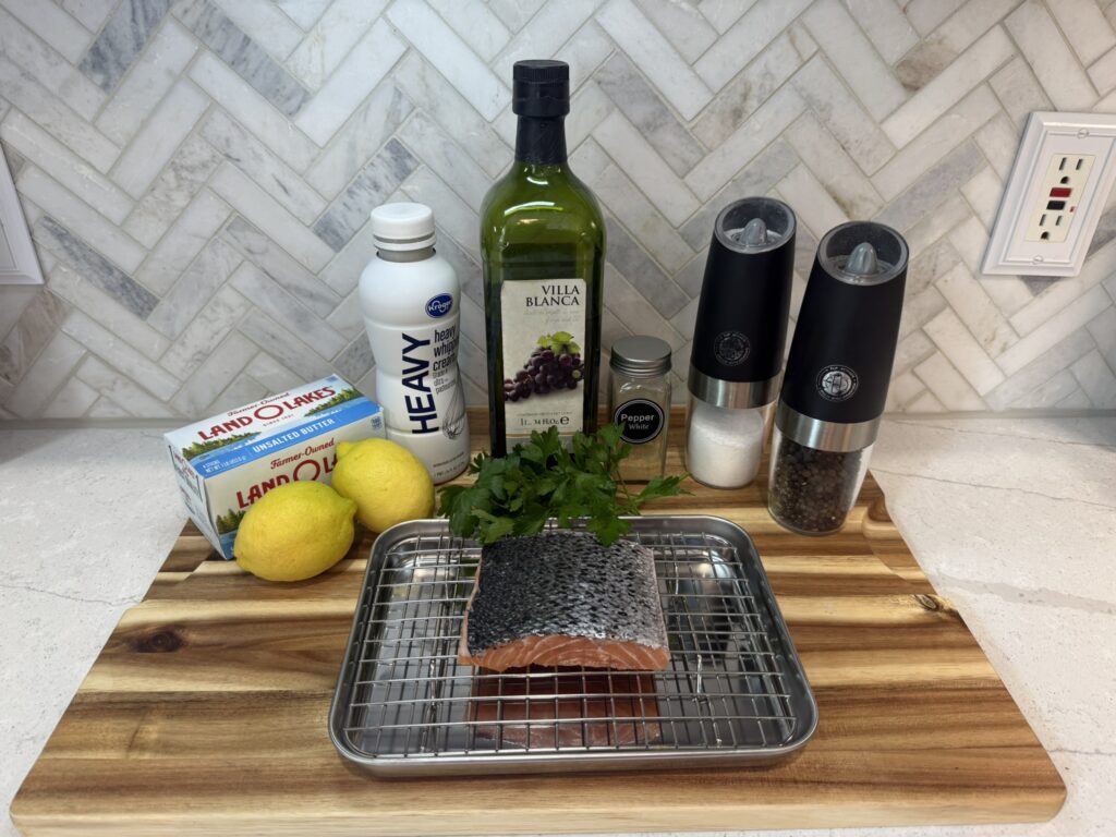 Ingredients on display: salmon, lemons, cream, butter, parsley, salt, and white pepper.