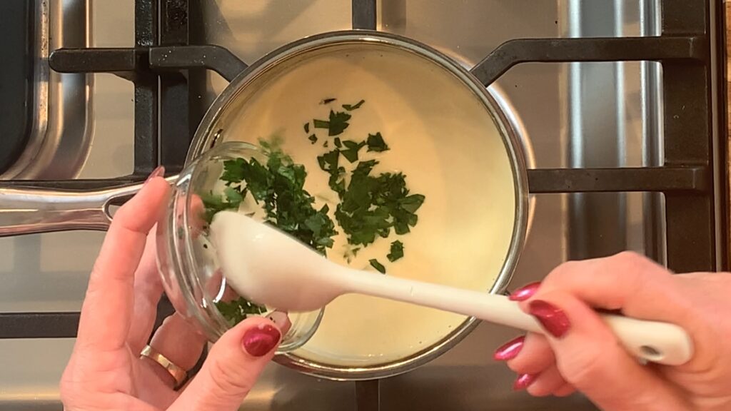 Parsley folded into sauce.