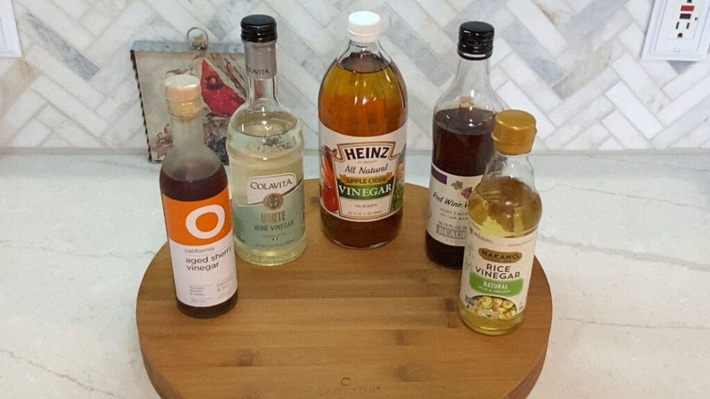 Bottles of different types of vinegar: sherry, white, apple, red, and rice wine that can be used to make a flavored mayonnaise. 