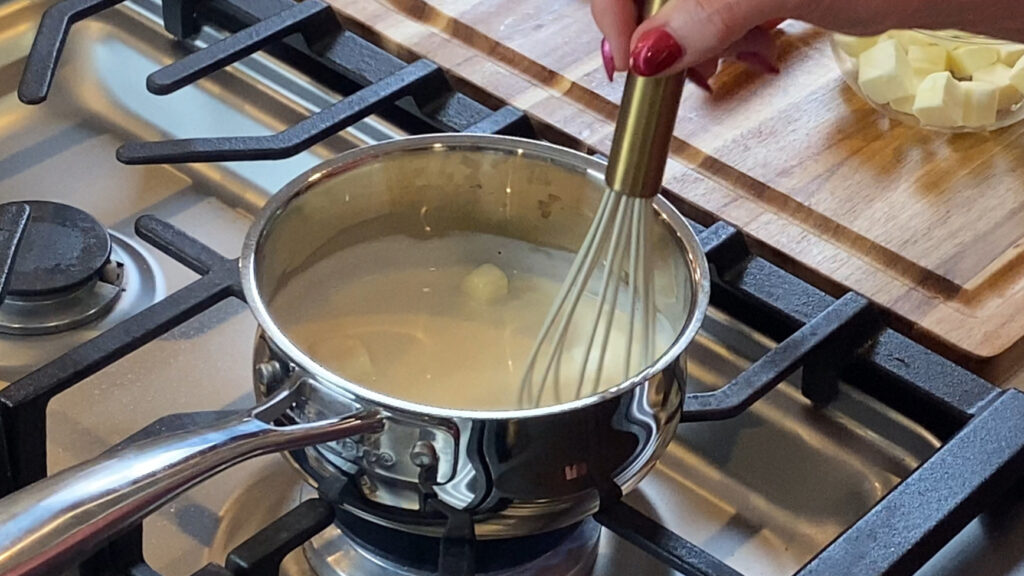 Butter being mounted into lemon and cream sauce.