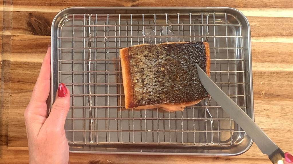 Salmon pulled from the oven, crispy skin visible