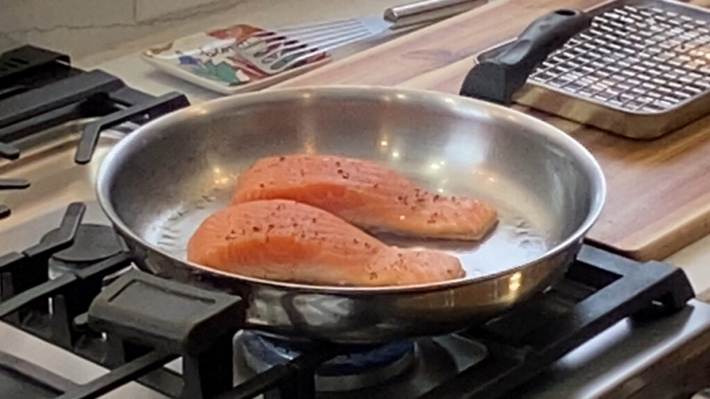 Salmon skin-side down in the pan