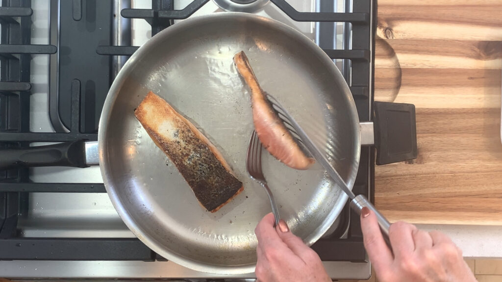  Salmon being flipped, showing the crisp skin