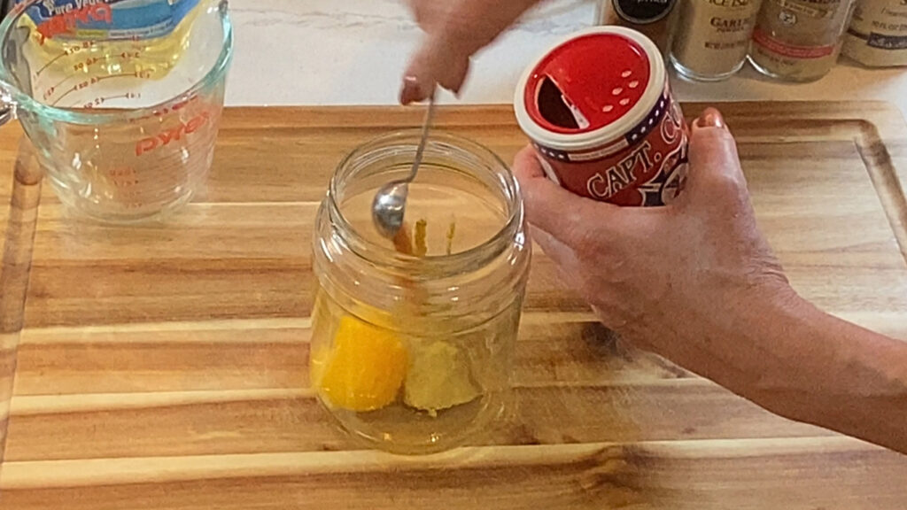 Spices and seasonings being added to the yolk mixture before the oil goes in